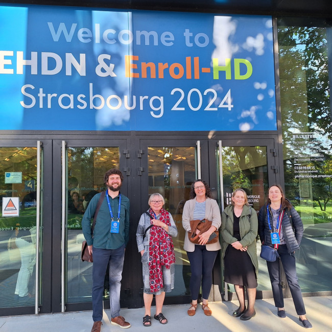 Staff from the EHDN standing in front of signage for the EHDN conference