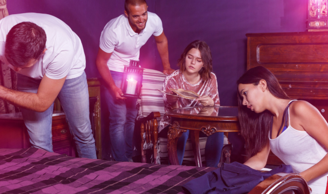 Four people looking for clues in an escape room