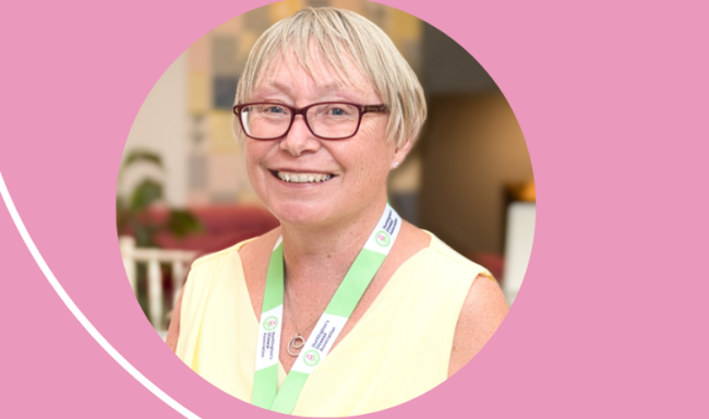 Picture of Cath Stanley smiling. Photo is on a pink background
