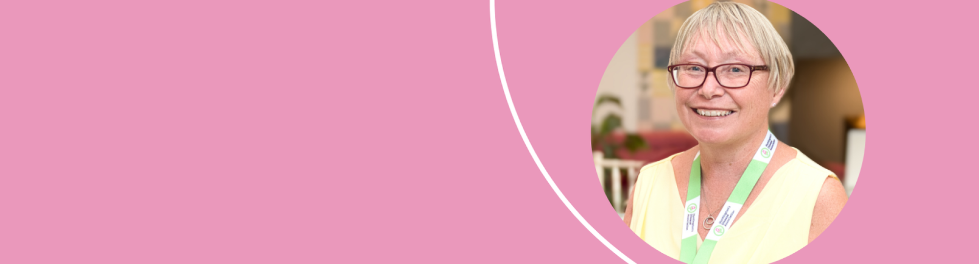 Photo of Cath Stanley smiling. Photo is placed on a pink banner